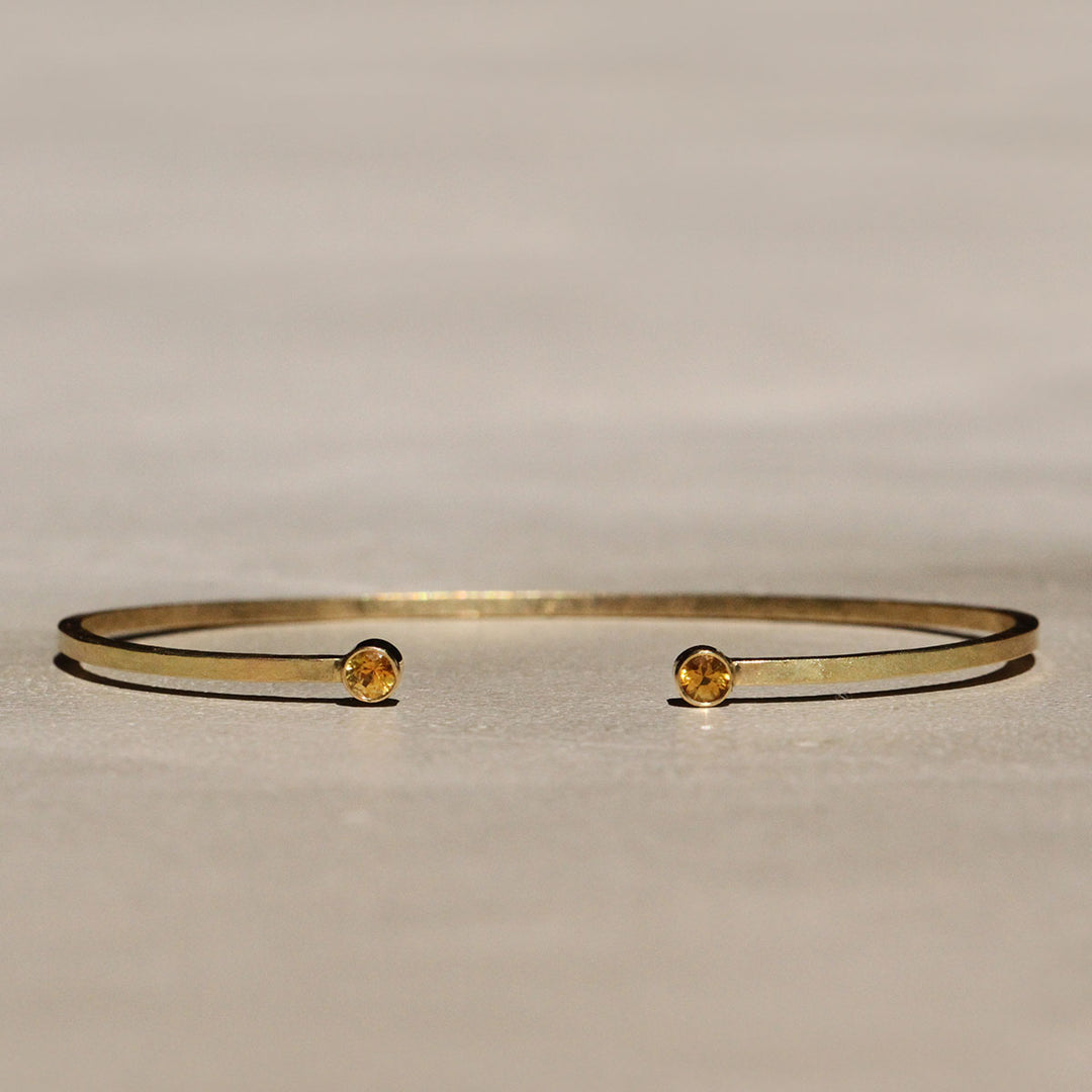 Sophie Hughes Yellow Montana Sapphire Cuff Bracelet in 18k Yellow Gold featuring two 3mm Dark Yellow Montana Sapphire round gemstones.