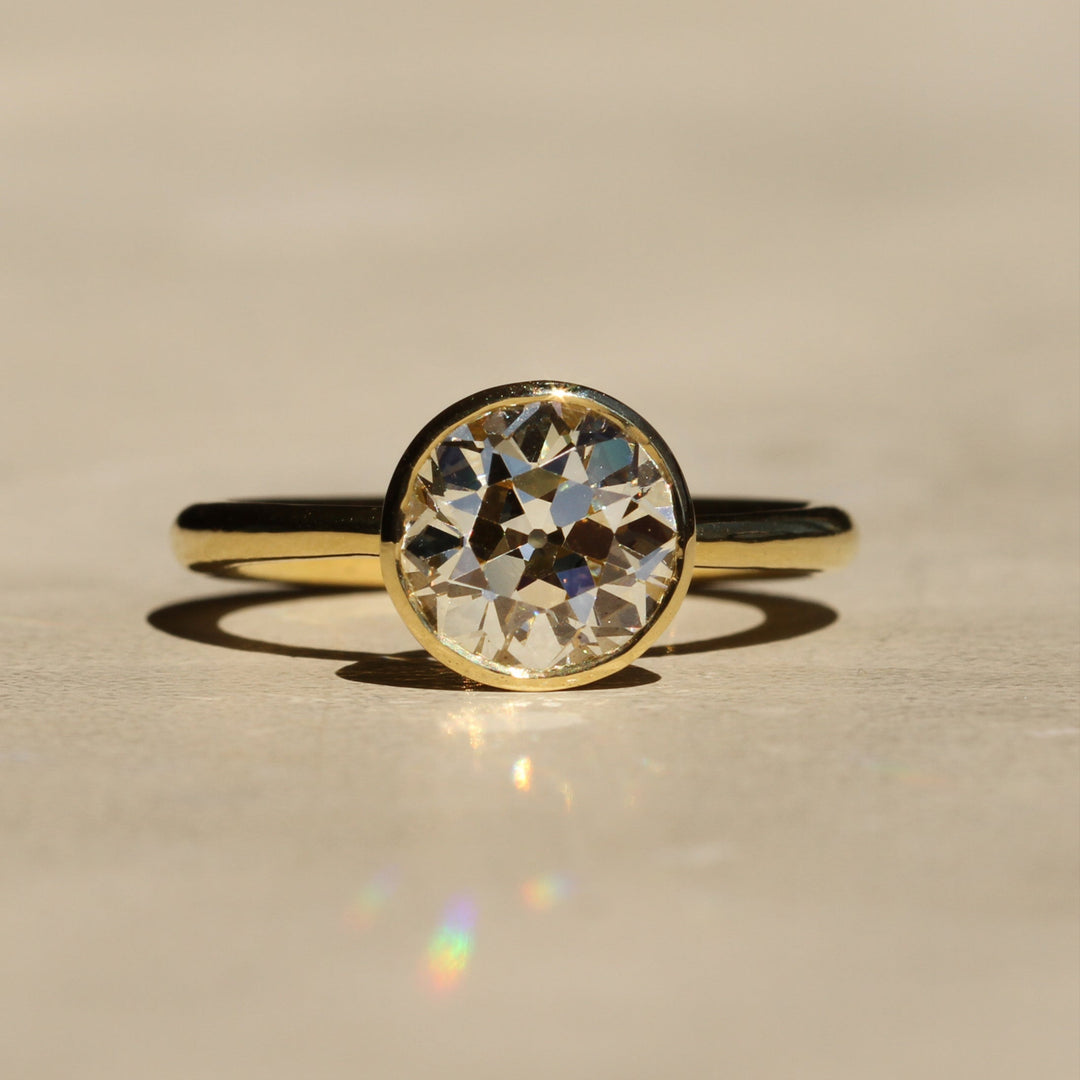 Sophie Hughes Tulip Bezel Solitaire in 18K Yellow Gold featuring a 2.5-ct Antique Old European cut diamond