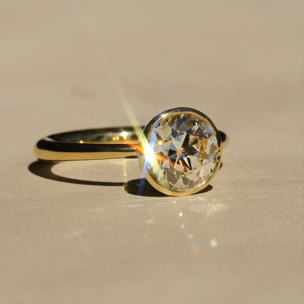 Sophie Hughes Tulip Bezel Solitaire in 18K Yellow Gold featuring a 2.5-ct Antique Old European cut diamond, at a slight angle