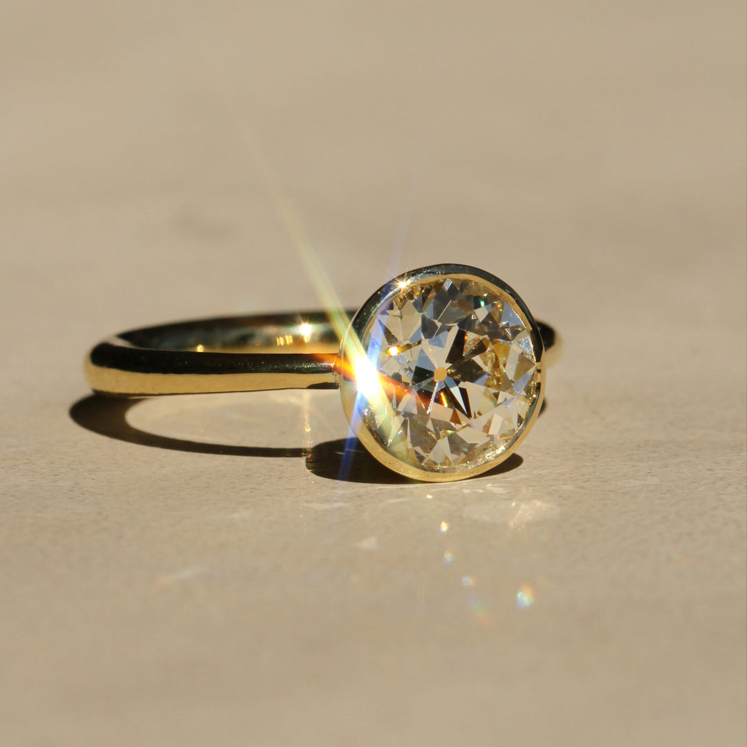 Sophie Hughes Tulip Bezel Solitaire in 18K Yellow Gold featuring a 2.5-ct Antique Old European cut diamond, at a slight angle