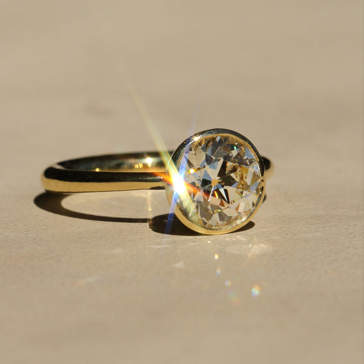 Sophie Hughes Tulip Bezel Solitaire in 18K Yellow Gold featuring a 2.5-ct Antique Old European cut diamond, at a slight angle