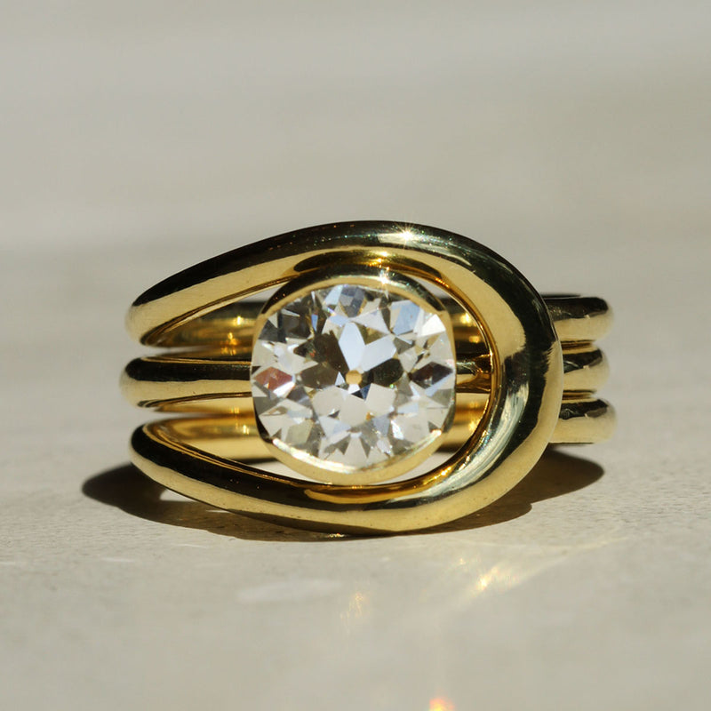 Sophie Hughes Poppy Bezel Solitaire in 18K Yellow Gold, featuring a 2-ct Antique Old European cut diamond, styled with the Sophie Hughes B.R.S. ring jacket