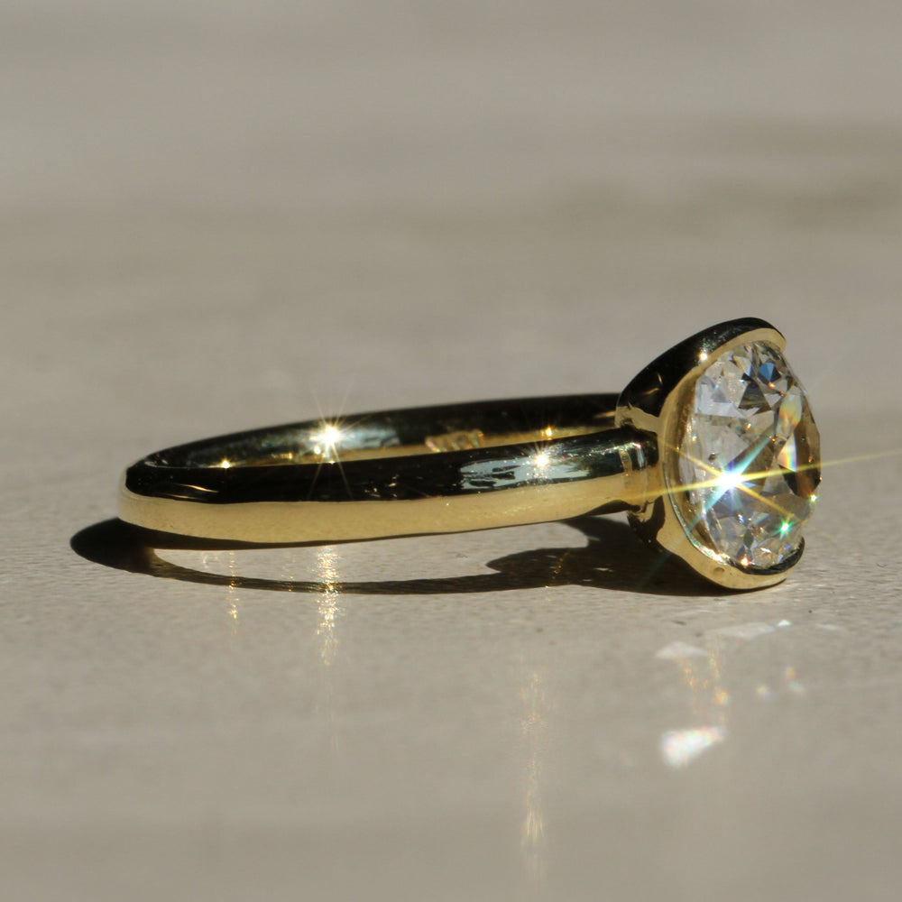 Sophie Hughes Poppy Bezel Solitaire in 18K Yellow Gold featuring a 1.5-ct Antique Old Mine cut diamond at an angle