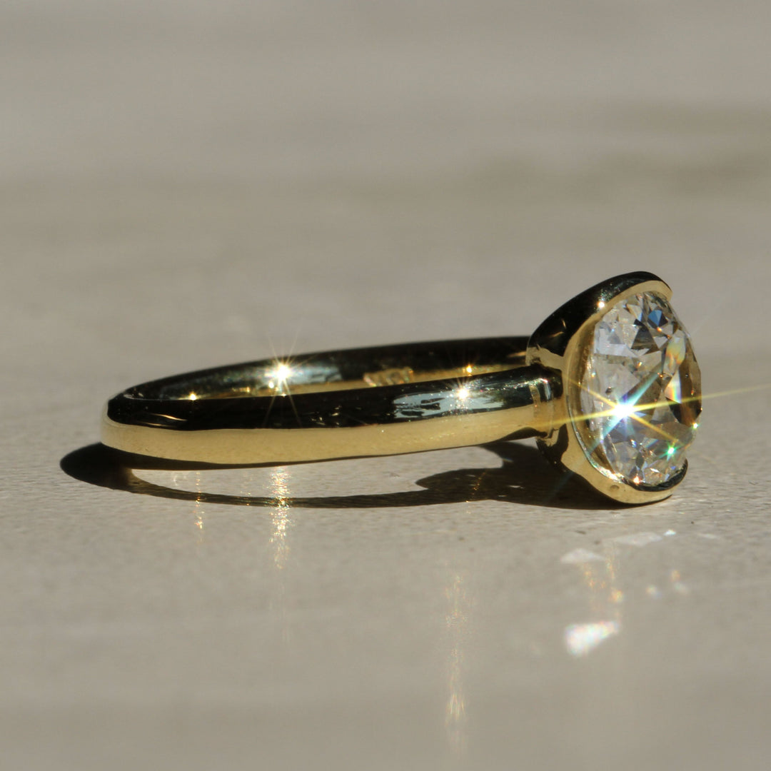 Sophie Hughes Poppy Bezel Solitaire in 18K Yellow Gold featuring a 1.5-ct Antique Old Mine cut diamond at an angle
