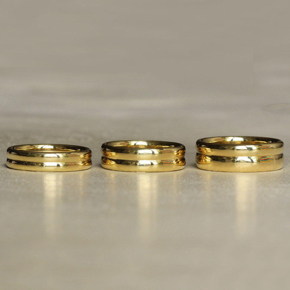 Three 18k Yellow Gold Bands of varying heights.