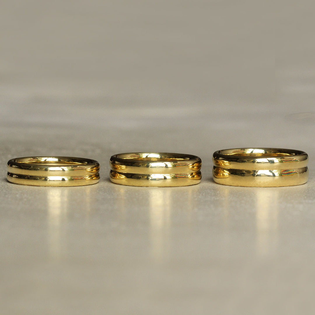 Three 18k Yellow Gold Bands of varying heights.