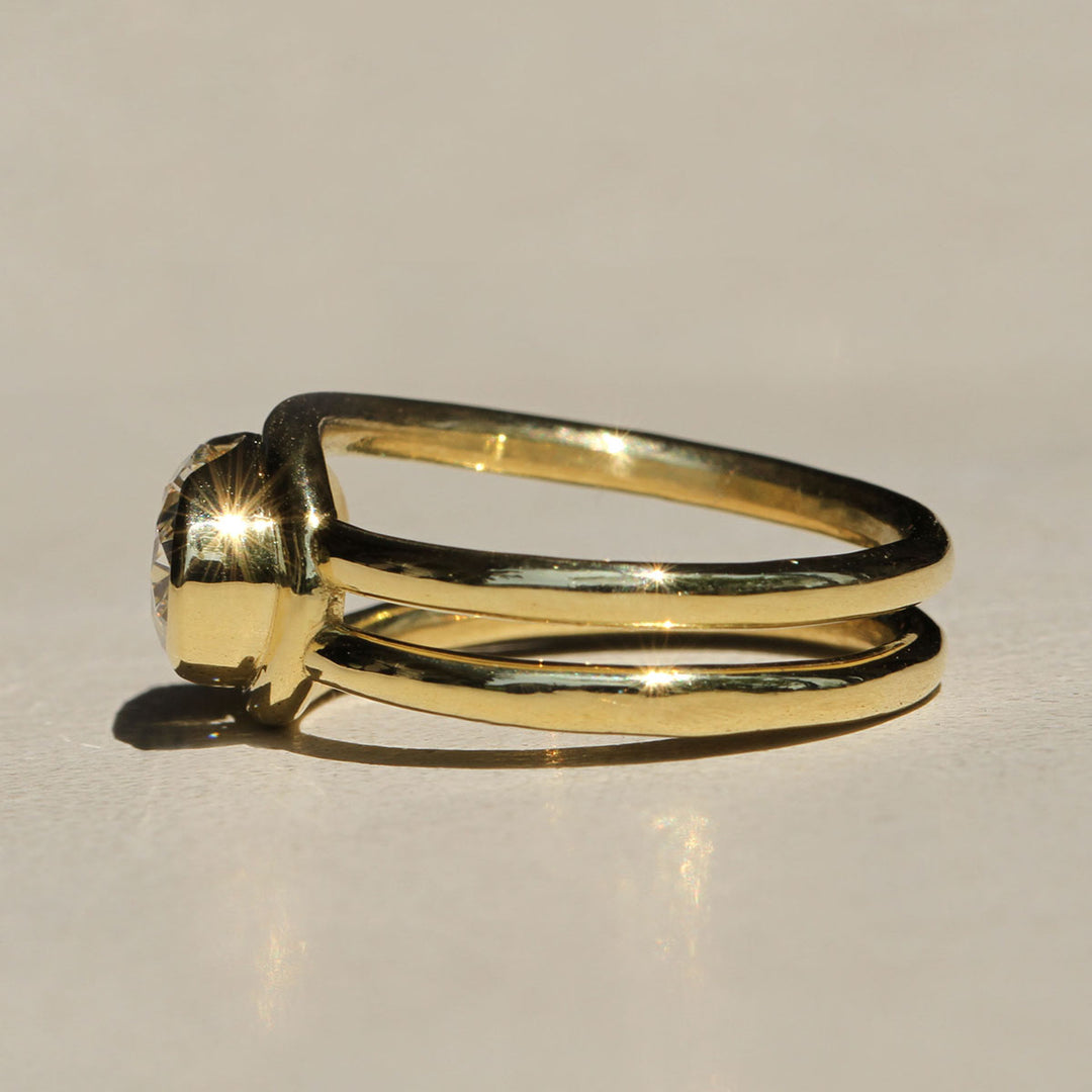 Sophie Hughes Poppy Bezel Loop Ring in 18k yellow gold featuring a 1.5-ct oval diamond set east-west, from the side