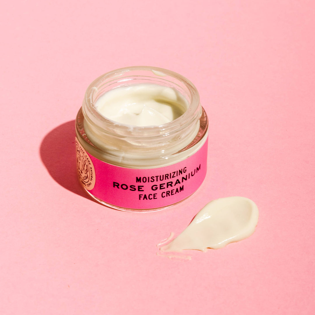 Jar of Good Flower Farm moisturizing rose geranium face cream with a pink label on a pink background