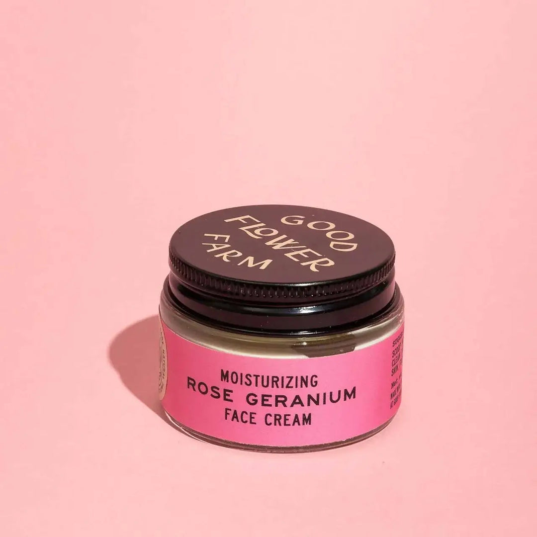 Jar of moisturizing rose geranium face cream from Good Flower Farm on a pink background