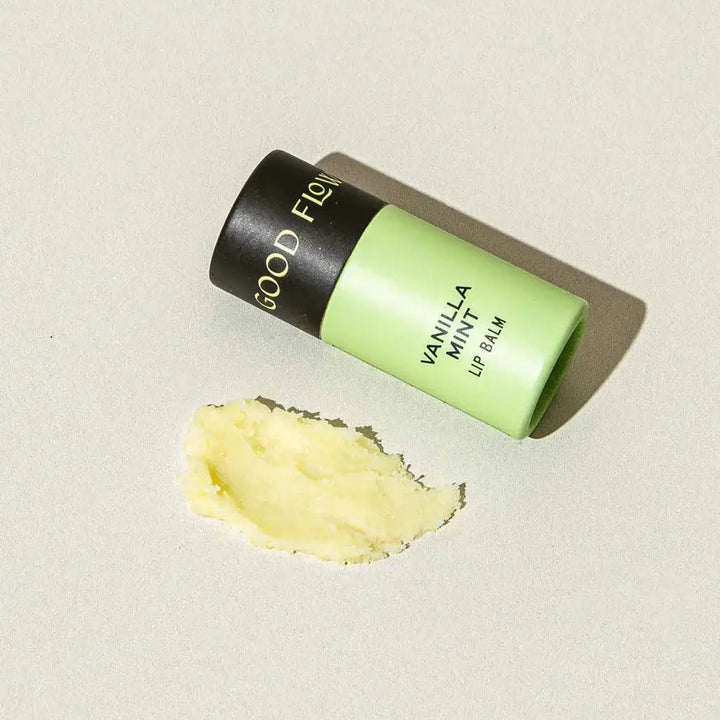 Good Flower Farm Vanilla Mint Lip balm container with a small amount of balm on a white background