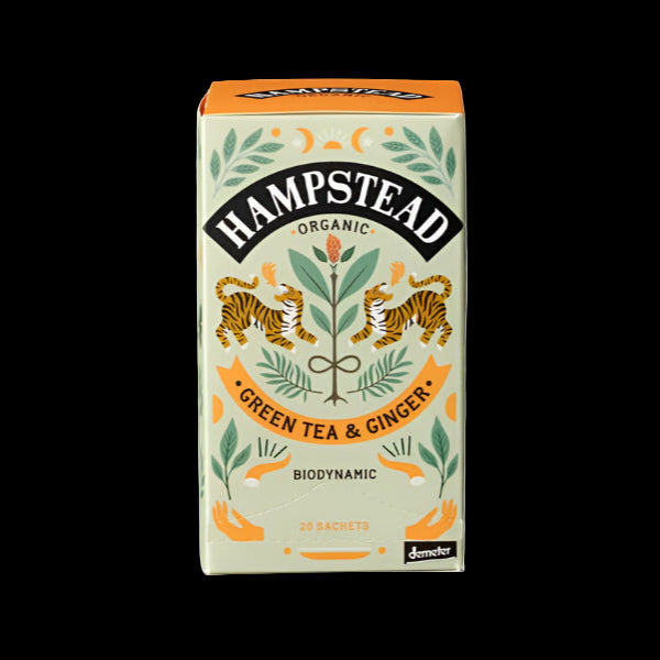 Packaging of Hampstead Organic Green Tea & Ginger. The box is predominantly white with green and orange accents, featuring illustrations of ginger roots and leaves, and text detailing the product and its organic nature.