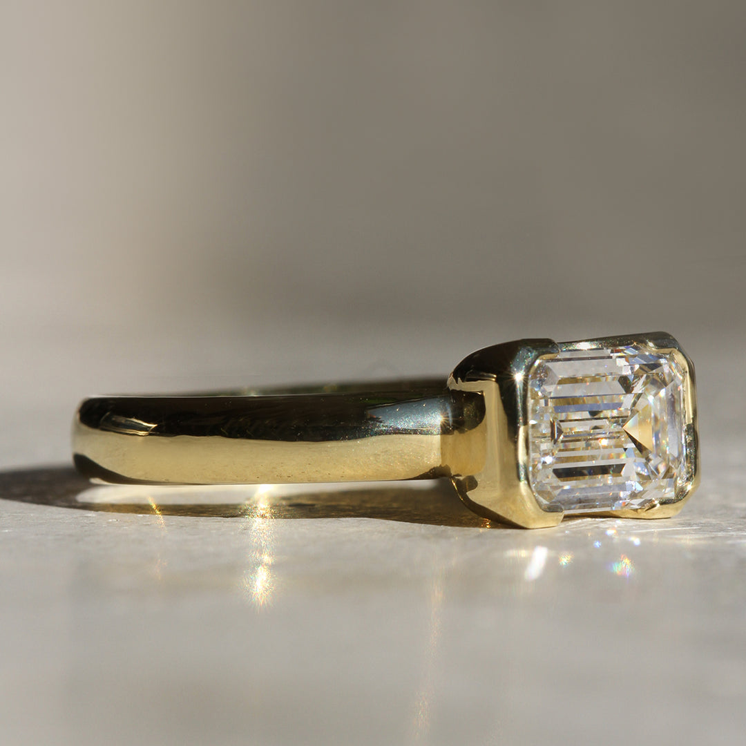 Poppy Bezel - East-West Emerald Cut Solitaire (LG)