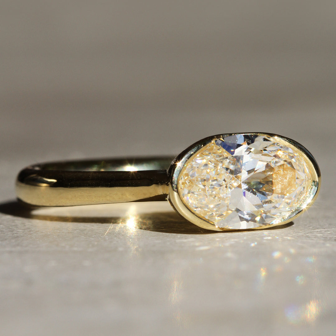 Poppy Bezel - East-West Oval Lofted Solitaire