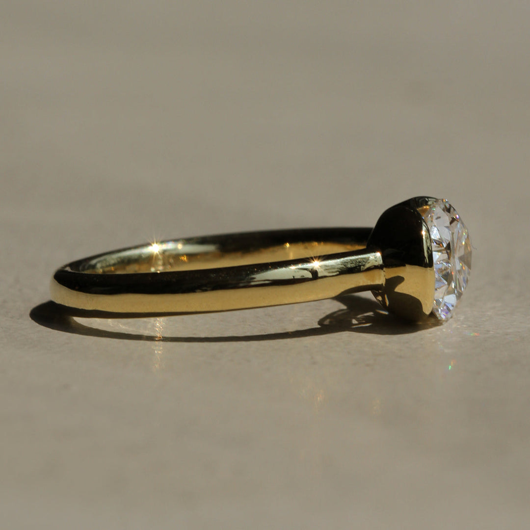 Poppy Bezel - East-West Oval Solitaire