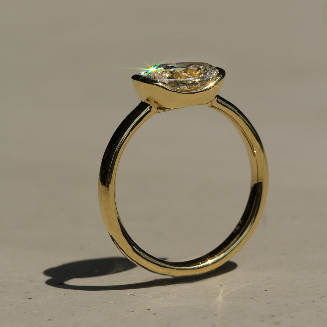 Poppy Bezel - East-West Oval Solitaire