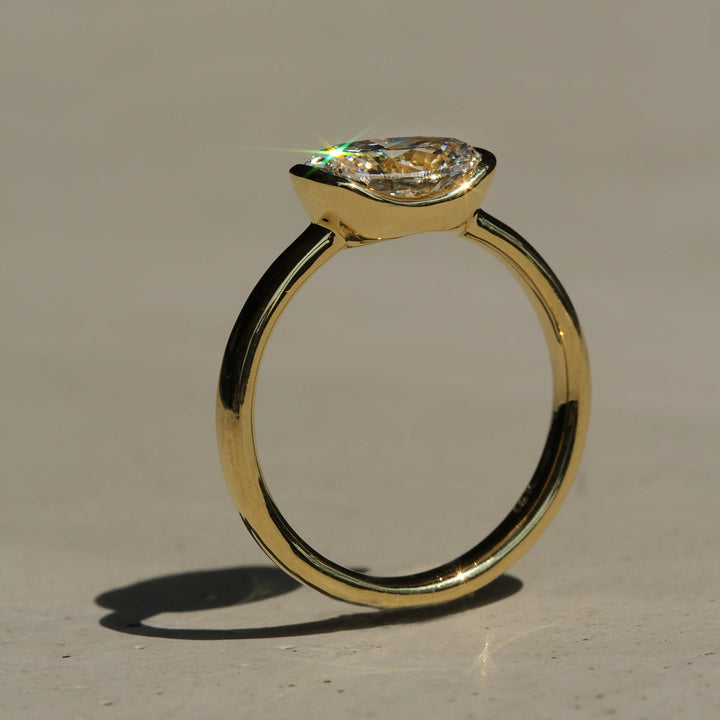 Poppy Bezel - East-West Oval Solitaire