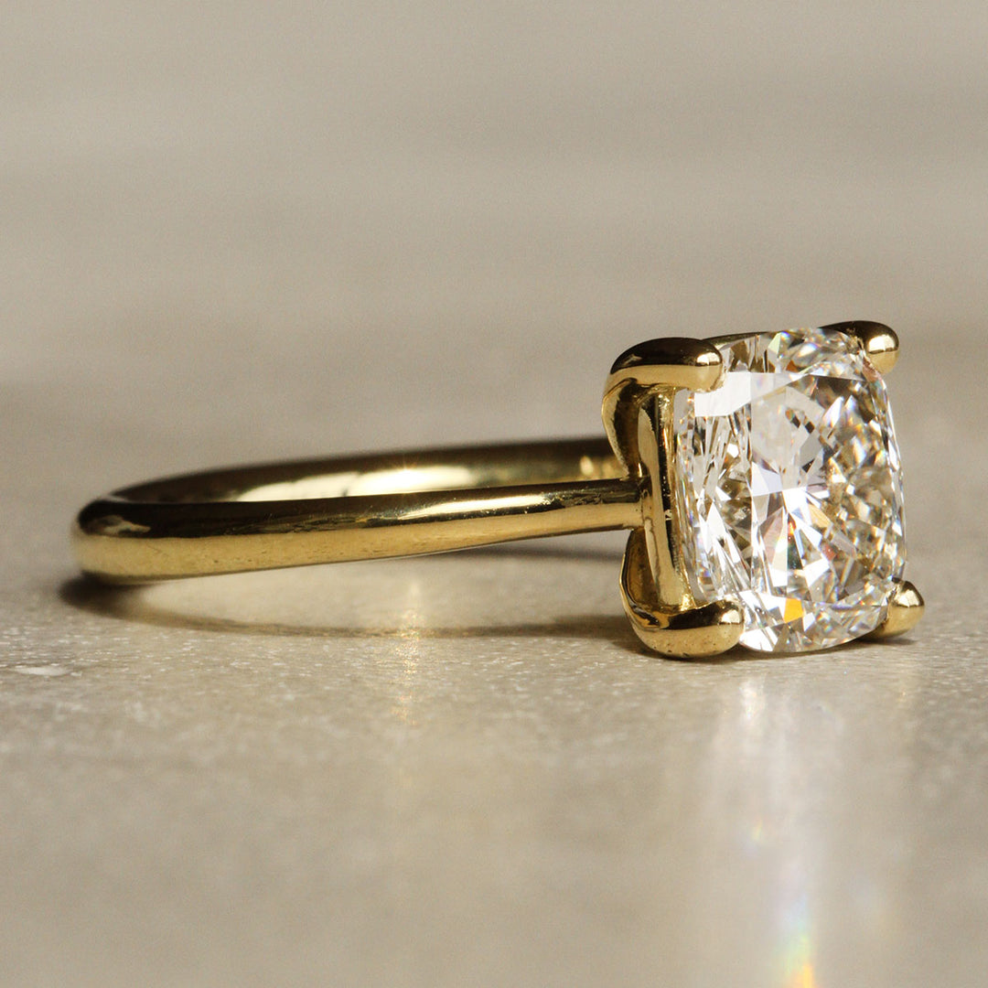 Sophie Hughes Iris Prong Solitaire in 18K Yellow Gold featuring a 3-carat Cushion Cut Diamond from a slight angle