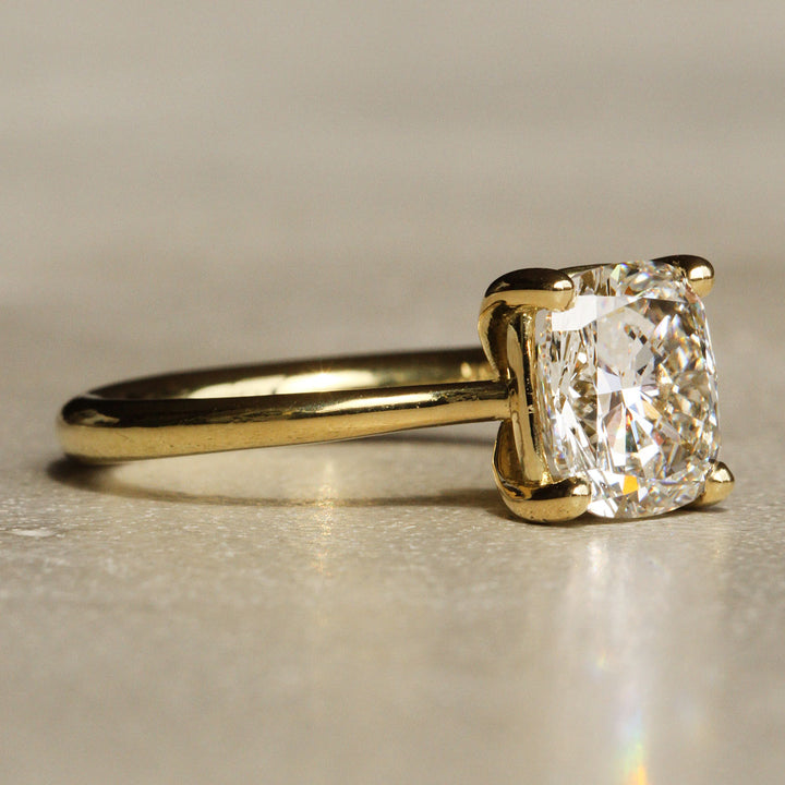 Sophie Hughes Iris Prong Solitaire in 18K Yellow Gold featuring a 3-carat Cushion Cut Diamond from a slight angle