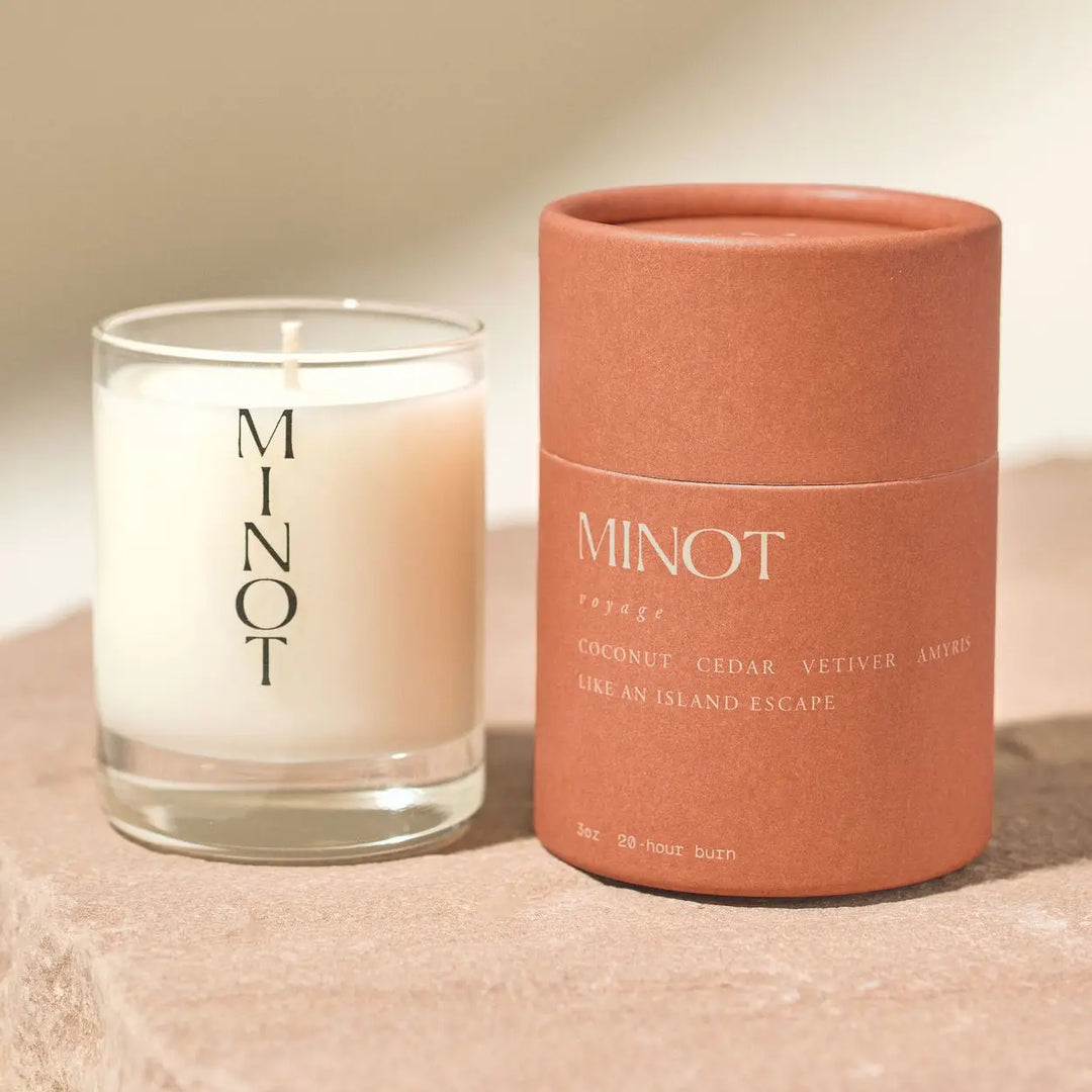 Minot candle and packaging on a beige background