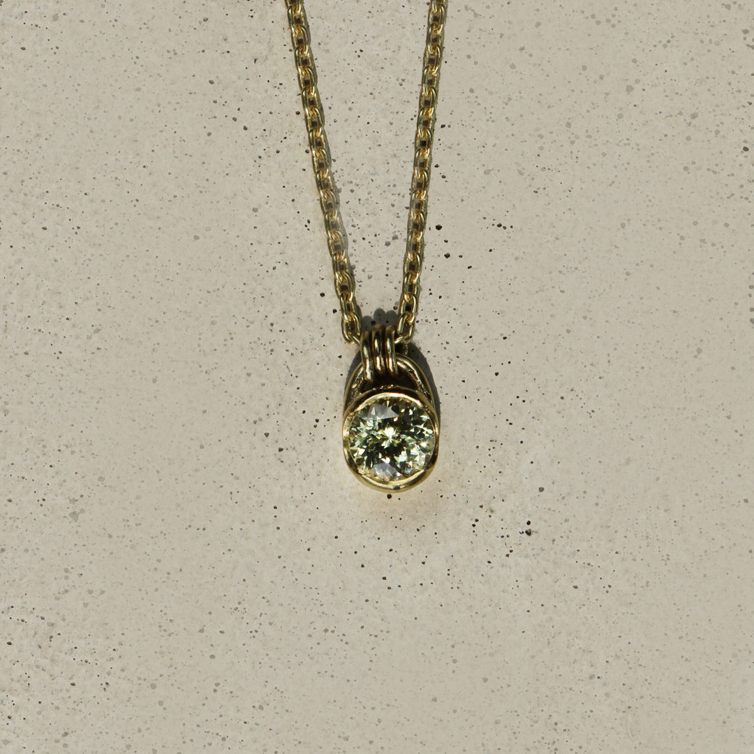 Sophie Hughes Poppy Bezel Montana Sapphire Necklace in 18K Yellow Gold featuring a 0.33-ct round brilliant light green sage Montana Sapphire