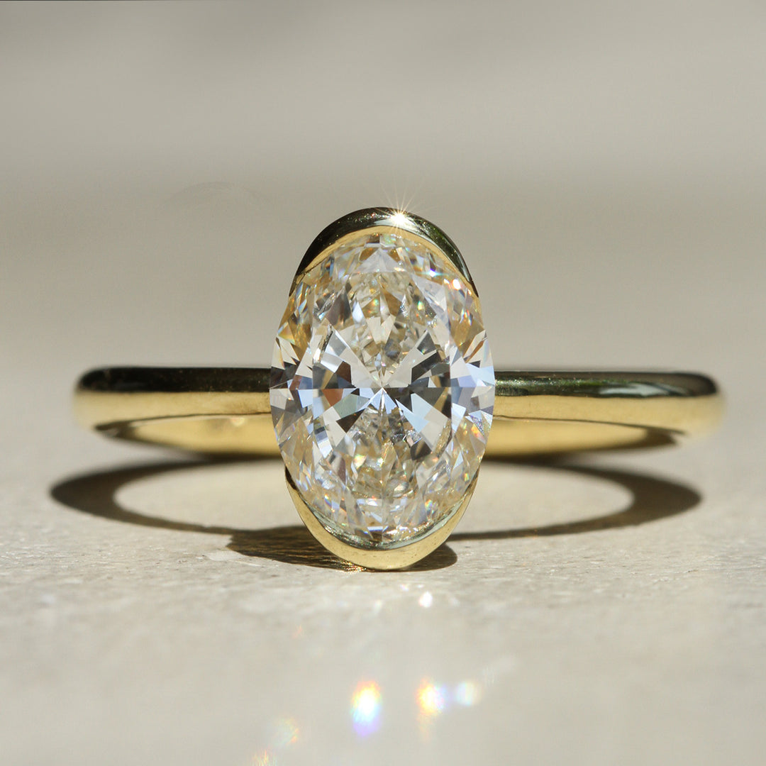 Sophie Hughes Poppy Bezel North-South Solitaire in 18K Yellow Gold featuring a 2-carat Oval Cut Diamond