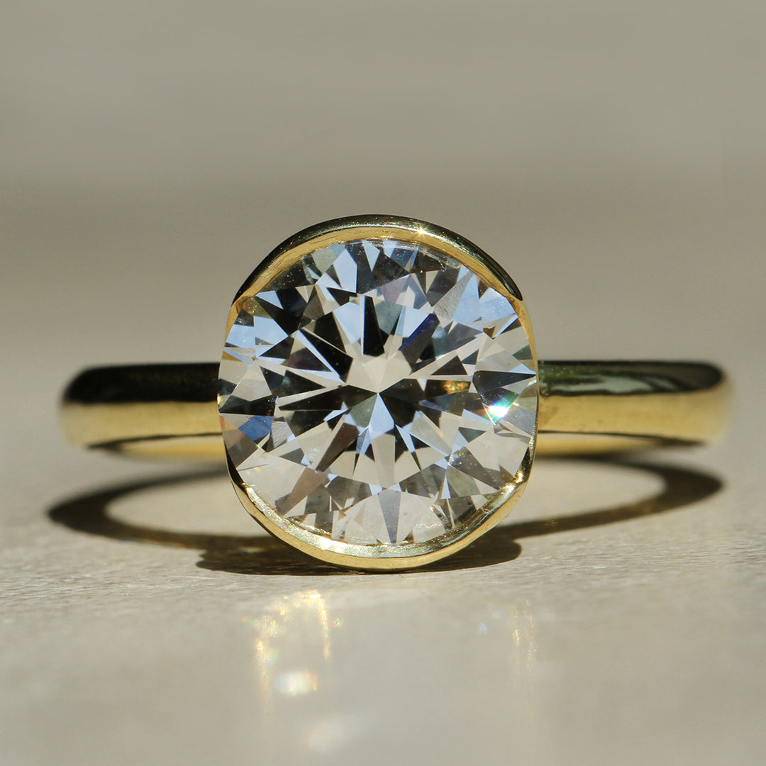 Sophie Hughes Poppy Bezel Lofted Solitaire in 18K Yellow Gold featuring a 3-carat Round Brilliant Cut Diamond