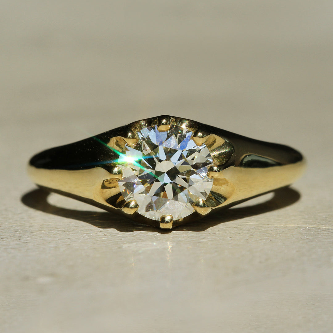 Recycled 18k Yellow Gold 8-prong ring with a Round Brilliant diamond on a neutral background.