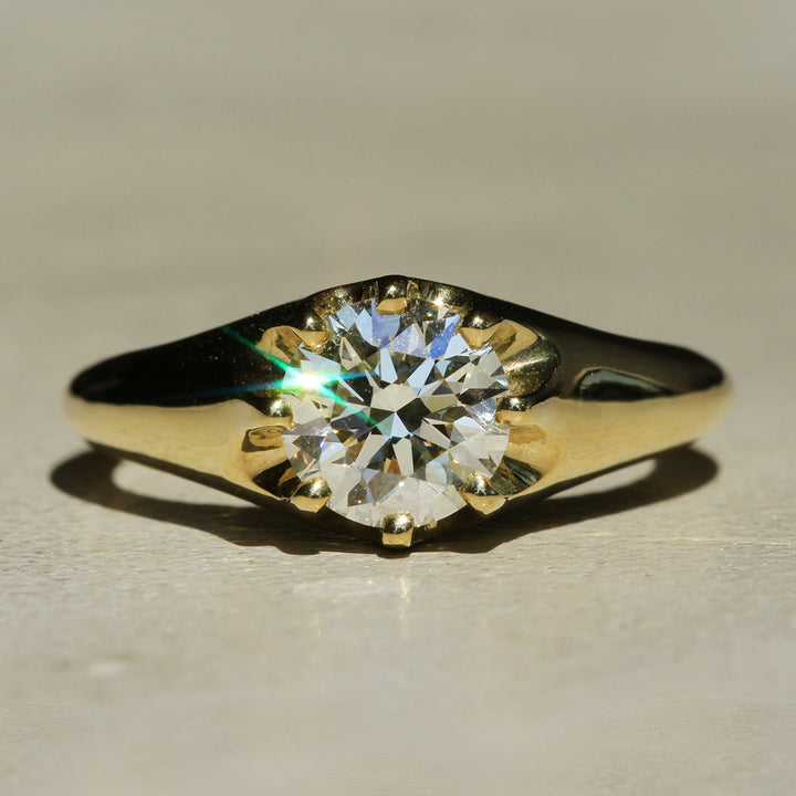 Recycled 18k Yellow Gold 8-prong ring with a Round Brilliant diamond on a neutral background.
