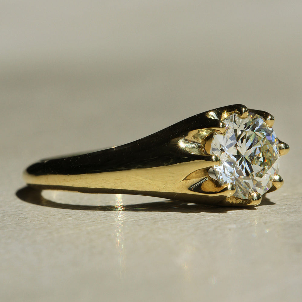 Recycled 18k Yellow Gold 8-prong ring with a Round Brilliant diamond on a neutral background at a slight angle.